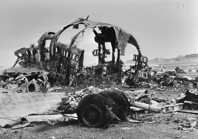 The burnt-out fuselage skeleton and landing gear of one of the Boeing 747s wrecked on the runway at Los Rodeos airport after the 1977 collision.