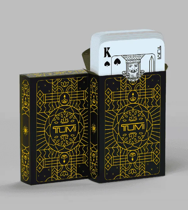 TUMI playing-card packaging with gold linework on black boxes