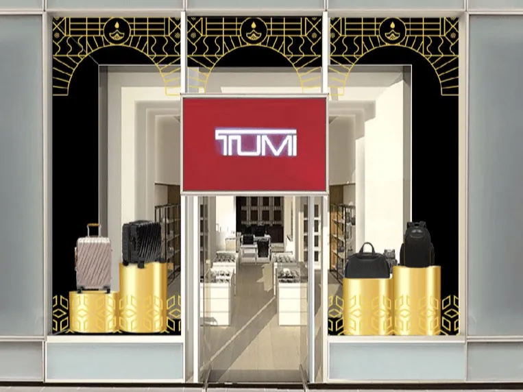 TUMI store entrance framed by the Diwali pattern, with bags on gold plinths
