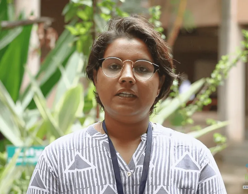 Fellow interview portrait: a woman wearing glasses outdoors