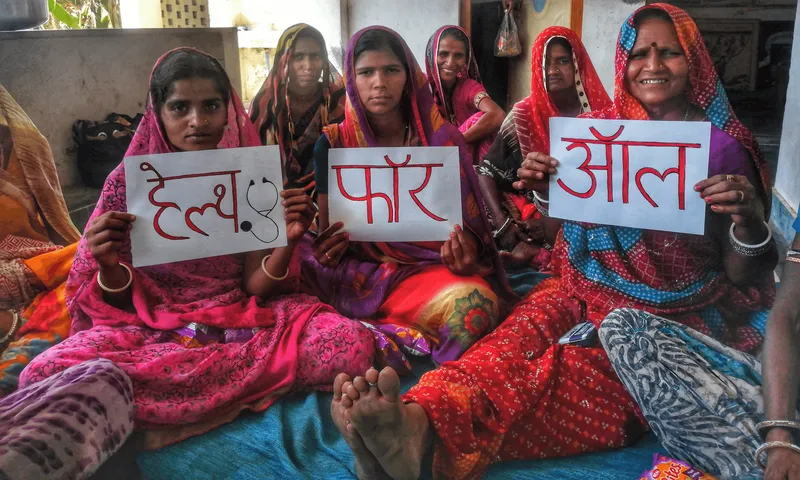 Community photograph of women holding Help for All signs