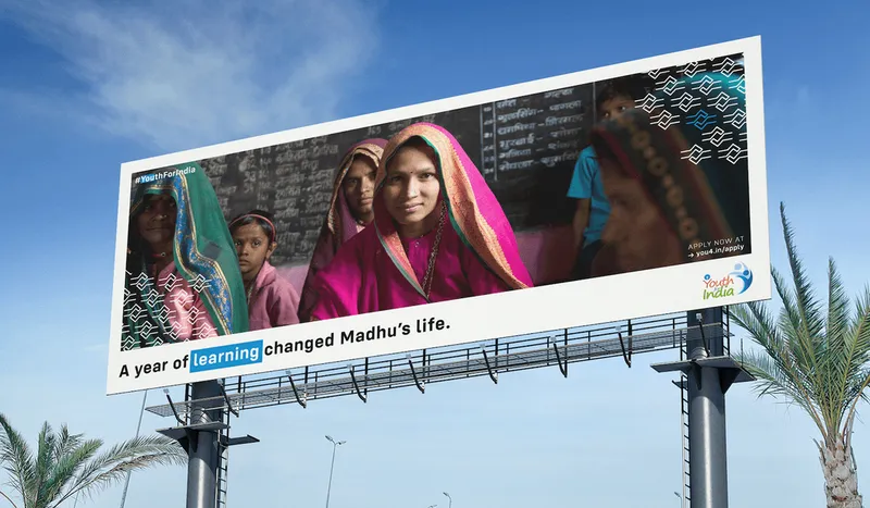 Outdoor billboard telling Madhu’s story of a year that changed her life